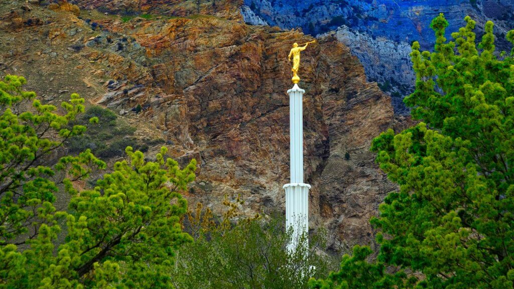 church steeple against mountain backdrop