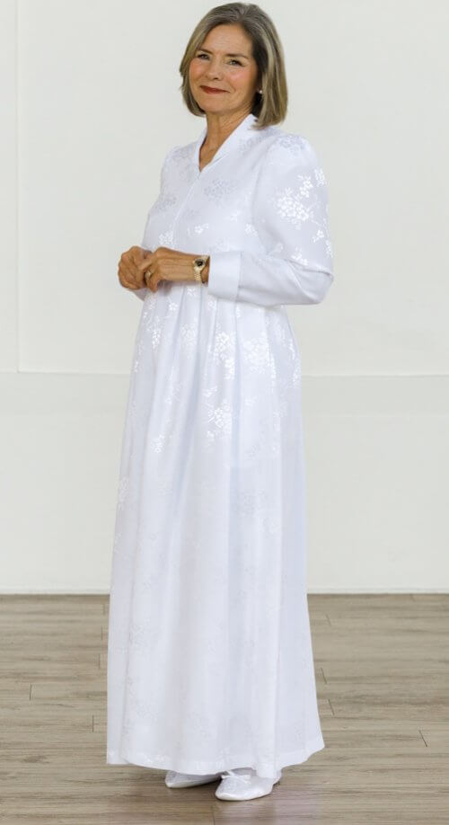 Nagoya Dress – Elegant white LDS Temple dress with a front zipper, floral jacquard fabric, pockets, and long sleeves.