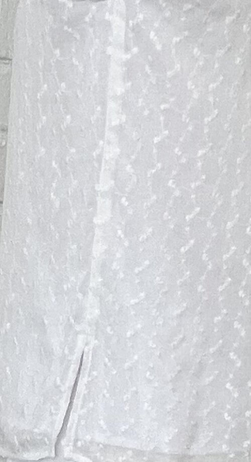 Close-up of the Bora Bora Set stitching, showcasing delicate white embroidery with a subtle pattern and a side vent detail for ease of movement.